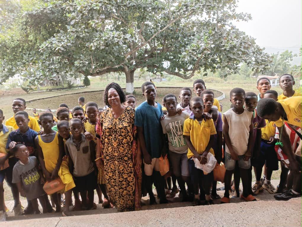 Foundation president with schoolchildren in Woraso